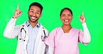Happy doctors, team and pointing up on green screen for advertising against a studio background. Portrait of man and woman in medical or healthcare teamwork show notification or alert on mockup space