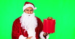 Green screen, Santa and Christmas present, surprise and secret gift or marketing for a deal, promotion or sale. Xmas, portrait and advertising for festive holiday, celebration or man in a costume