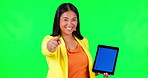 Tablet, advertising campaign and a woman on green screen background in studio holding a display with tracking markers. Portrait, target audience and a happy young asian female holding chromakey