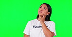 Volunteer, thinking and a woman on a green screen for solution, charity or funds. Face of serious asian person with hand and tshirt for nonprofit or NGO problem solving for help or donation in studio