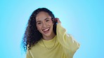 Wow, funny and flirt with a cute woman in studio isolated on a blue background while laughing at a compliment. Portrait, face and surprise with a young female comic looking playful while joking