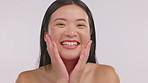 Asian woman, happiness and touch face with beauty, skin glow and laughing on studio background. Smile, happy and young, dermatology and female model, skincare and natural cosmetics with mockup space