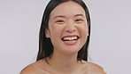 Japanese woman, face skincare and studio with smile, laughing and cosmetics by white background. Happy Asian girl, young model and makeup with beauty, wellness and self care with natural aesthetic