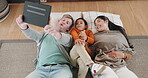 Happy family, tablet and silly face for selfie, picture or photo relaxing together in living room at home. Goofy father, child and mother in relax with technology or smile for funny memory or bonding