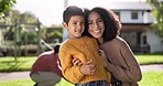 Family, mother and son on lawn with bonding, hug outdoor with support and care, trust and love with spending time together. Woman, boy child and relax at home, portrait and happiness in garden