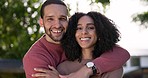 Love, nature and couple hugging in a garden or park for a romantic outdoor date together. Happy, smile and portrait of a young man and woman embracing with romance and care on holiday in countryside.