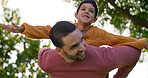 Father, son and piggyback, bonding outdoor and happy with quality time together, playful and fun in garden. Man, boy child and swinging in park, relax in nature with summer and family, love and care