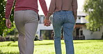 Back, walking and a couple holding hands in the garden of their new home together during summer. Love, real estate or property with a homeowner man and woman taking a walk together on backyard grass