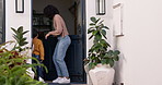 High five and mother welcome son walking in a home after playing, happy and excited at a house door together. Childhood, care and young mom walking in with a child or kid with happiness and bonding