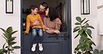 Happy, conversation and couple talking to their child by the door of their family house for fresh air. Love, smile and young parents speaking, holding and bonding with boy kid by modern home together