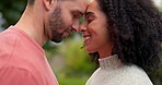 Love, park and couple embrace in woods on vacation with a smile and freedom together. Calm, happy and young people with a hug in nature on a date and holiday with man and woman bonding outdoor