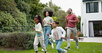 Family, running and children outdoor in backyard for playing, happiness and bonding at home. Young latino woman, man and happy kids at a playground while on holiday or vacation for a fun activity