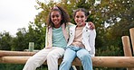 Friends, happy and children hug in park on jungle gym for bonding, childhood and having fun on playground. Friendship, outdoors and portrait of young girls embrace for playing, freedom and adventure