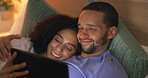 Couple, smile and relax in bedroom with tablet at night, streaming movie or film. Happy, technology and man and woman in bed on social media, browsing online app and watching video together in home