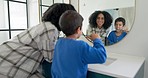 Woman, child and brushing teeth in bathroom with mirror, dental care in home with toothpaste, water and hygiene. Kid, mom and toothbrush, teaching, learning and cleaning mouth morning with reflection