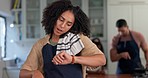 Time, kitchen and woman cooking at house on a phone call for dinner, event or supper with family. Late, mobile conversation and young female person checking a watch on her watch while baking at home.