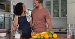 Love, hug and couple in a kitchen cooking, happy and bond in their home together. Smile, embrace and happy man with woman preparing a meal for lunch or dinner in their house, romantic and sweet