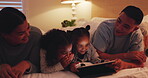 Funny, tablet and family in bedroom at night, bonding and streaming movie, video and relax. Technology, children and parents on bed, laughing or social media for gaming, app or happy together in home