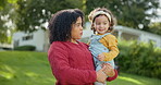 Family, kids and a mother with her adopted daughter in the garden of their foster home together. Love, smile and children with a stepmother holding her female child outdoor in the home backyard