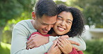 Love, smile and a married couple hugging in the garden of their home together for romance during summer. Spring, dating and smile with happy young people in the backyard while bonding in spring