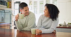 Couple, happy together and laughing with coffee in morning conversation, quality time and funny joke in home or kitchen. Drinking, tea and people dating, talking and happiness in relationship