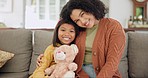 Home, mother and girl on a couch, bear and relax with happiness, loving together and quality time. Face, mama and daughter on a sofa, child development and freedom with a smile, mom and female kid