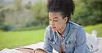 Black woman, reading a book and relax in the park, nature on a study break, rest and research on university campus grass. Girl, learning a story and college textbook, novel or literature for class