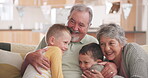 Grandparents, family and children hug on sofa for love, retirement and bonding together at home. Senior people, grandmother and grandpa with kids on couch for happiness,  group support and care