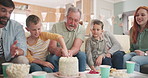 Birthday, big family and cutting cake together for party food, celebration or dessert. Happy, help and kid with a knife for a sweet treat with parents, grandparents and sibling in a house for a treat