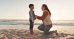 Summer, love and a mother with her son on the beach at sunset for travel, vacation or holiday together. Sea, children or family with a woman parent talking to her male child on the sand for bonding