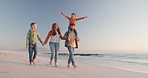 Holding hands, smile and family on a beach, walking and happiness with joy, summer and holiday with getaway. Parents, mother and father with children, kids and seaside with wellness, travel and ocean