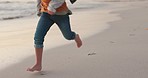 Travel, vacation and closeup of a child running on the beach for adventure, freedom or fun. Barefoot, speed and zoom of a boy kid walking on the sand by the ocean or sea while on a tropical holiday.