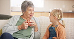 Communication, grandmother with child talking and on sofa in living room of their home. Networking or consulting, bonding time with coffee or advice and happy people have a discussion on couch 