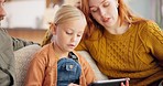 Parents, girl kid and tablet in home for online games, elearning app and educational subscription on sofa. Mom, child and dad with family connection on digital technology, streaming cartoon and media