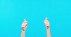 Person, hands and thumbs up for winning on mockup in success or good job against a blue studio background. Hand showing thumb emoji, yes sign or like for agreement, approval or thank you in promotion