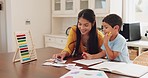 Mother helping her child with homework at their home in the dining room with math flash cards. Learning, education and young woman teaching her boy kid counting with abacus for school in their house.