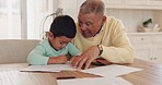 Grandparent, talking or child drawing in books for learning development together in family house. Support, homework or grandfather teaching a creative boy or artistic kid writing skills or bonding