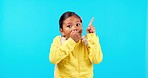 Face, hand pointing and wow by girl child in studio with back to school sale, announcement or promo on blue background. Omg, news and kid portrait with kindergarten deal, coming soon or information