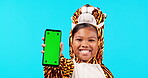 Happy little girl, phone and mockup screen in costume for advertising against a blue studio background. Portrait of female child or kid with smile and mobile smartphone app or chromakey display