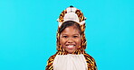 Excited, tiger costume and face of girl in studio isolated on a blue background mockup space. Portrait, smile and happy child with positive mindset in animal cosplay, funny laugh and play dress up.