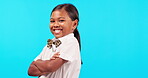 Bow tie, children and an indian girl arms crossed on a blue background isolated in studio for fashion or trendy style. Portrait, kids and an adorable female child posing indoor in a stylish outfit