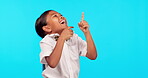 Girl laughing, child and  pointing at bullying, joke or funny comic on studio, blue background or mockup. Female student, kid with crazy laugh or point at menu, choice or comedy with happy smile