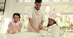 Baking, flour and a father teaching his girls about cooking in the kitchen of their playful home together. Pastry, children or family fun with sister siblings learning about food from from their dad