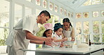 Baking, dough and parents teaching their girls about cooking in the kitchen of their home together. Pastry, children or family with female kids learning about food from mom and dad in the house