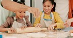 Girls, family and roll dough for cooking, learning and having fun together while bonding. Kitchen, sprinkle flour and parents with happy children, mother and father for education, baking and food.