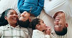 Conversation, relax and parents talking to their children on the bed while having fun, resting and bonding. Happiness, smile and young kids speaking with their mother and father in bedroom at home.