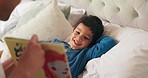 Father, son and bed with book, story and reading together with learning, knowledge and happy in family home. Dad, male child and teaching at bedtime, care and love with bonding, bedroom and night