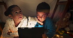 Night, tablet and children streaming in a tent house talking about internet video, show or movie online at night. Dark, digital and siblings or kids relax with watching cartoon app in the evening