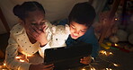 Funny, tablet and children streaming a cartoon in a tent house laughing at internet video, show or movie online at night. Dark, digital and siblings or kids relax watching comedy in the evening