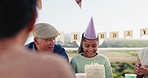 Cake, family and girl in park for birthday, celebration and party event outdoors for social gathering. Happy, lunch and mother, grandfather and children at picnic with dessert, presents and surprise